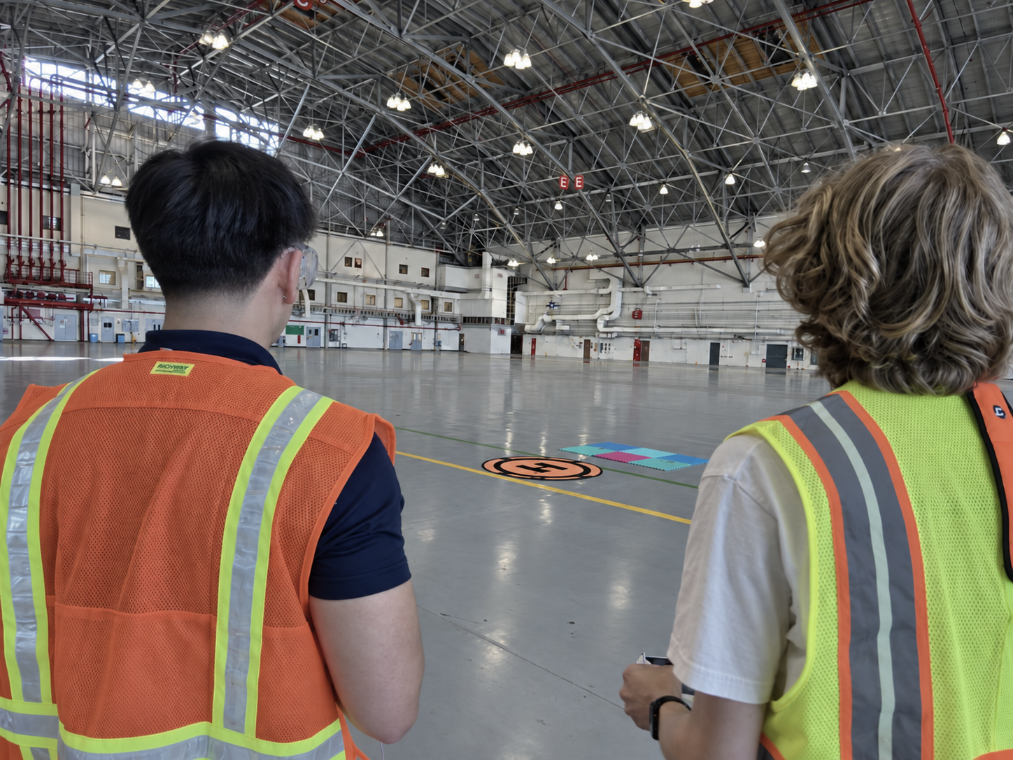 Two engineers conducting indoor piloted UAS testing in the NASA Ames Smart Mobility Laboratory